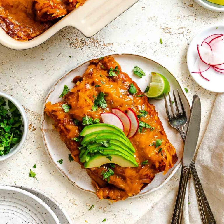 Completed Vegan Cheese Enchiladas in baking dish and plate.