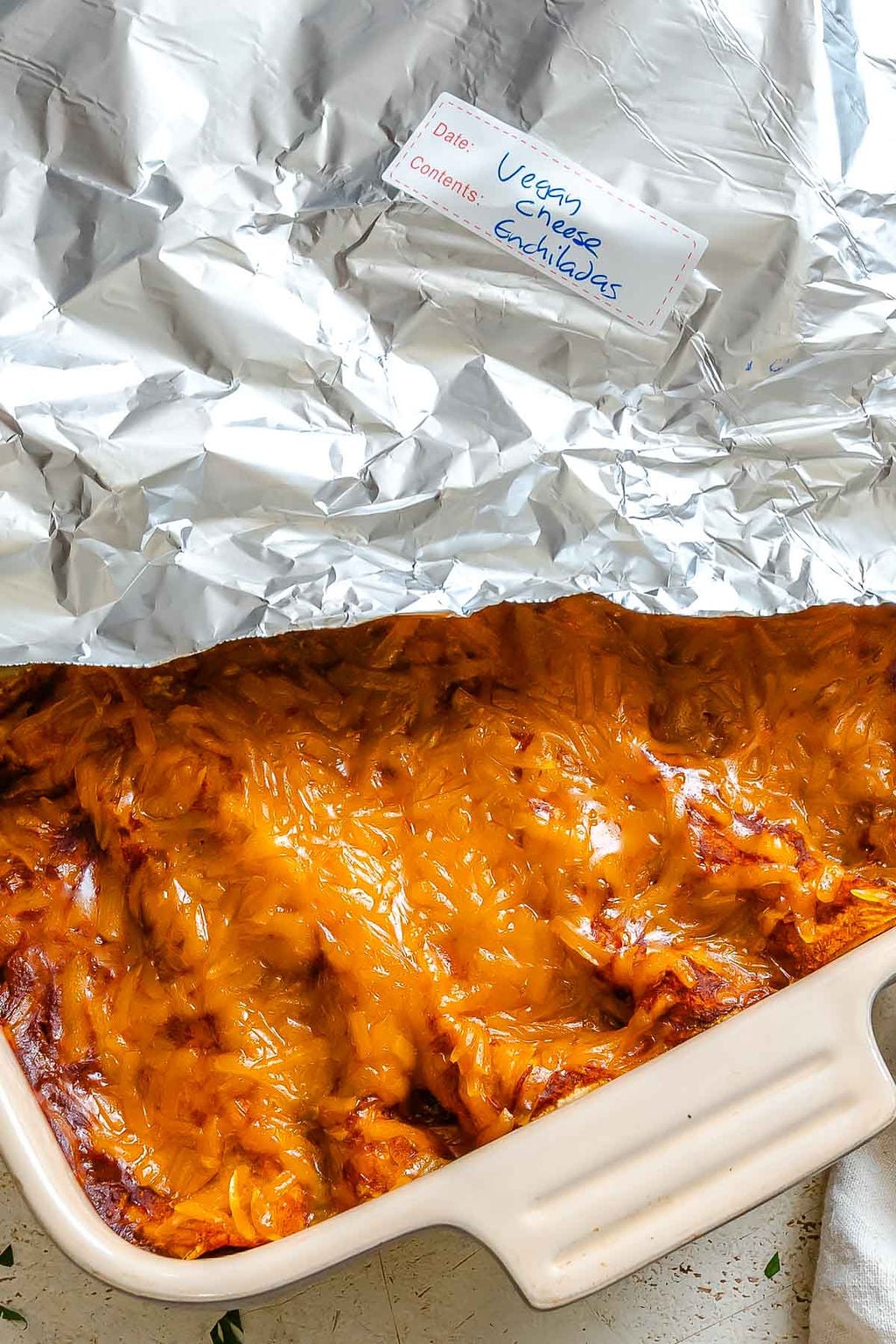 Completed Vegan Cheese Enchiladas in storage dish.