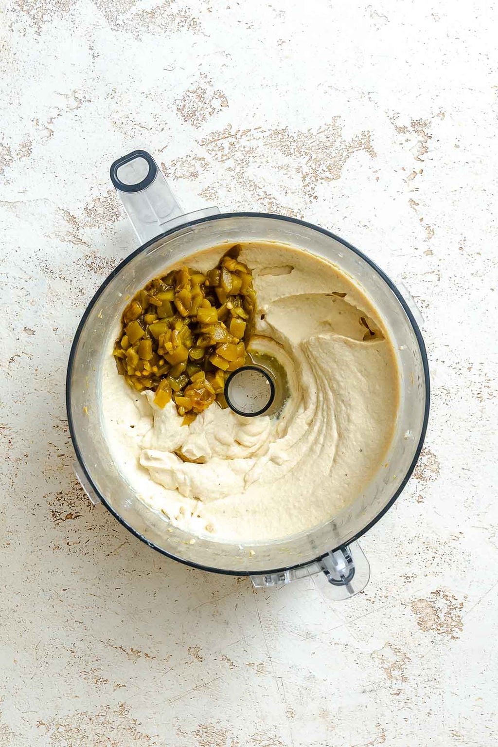 Process shot showing ingredients added to food processor.