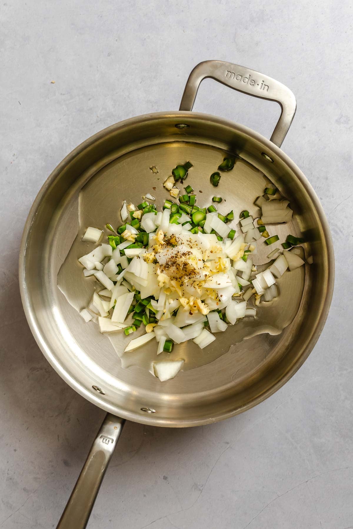 Process shot showing ingredients added to a pot.