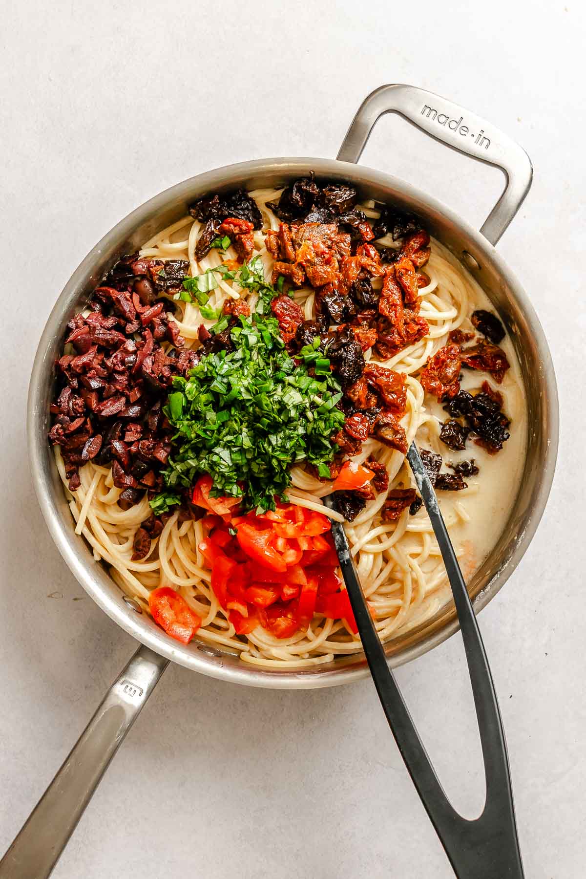 Process shot showing ingredients added to pan.