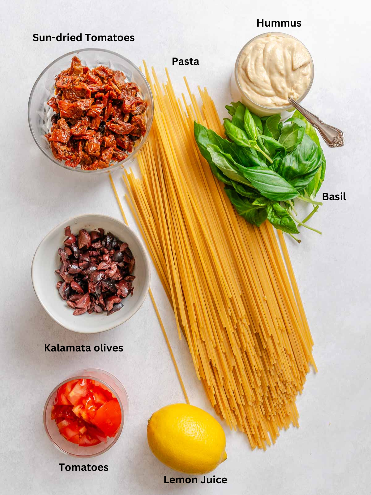 Ingredients for Creamy Hummus Pasta measured out on a white surface.
