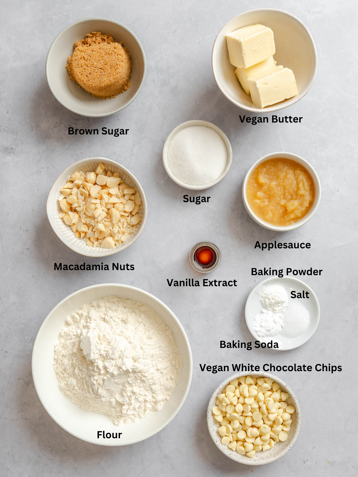 Ingredients for White Chocolate Macadamia Nut Cookies measured out on a white surface.