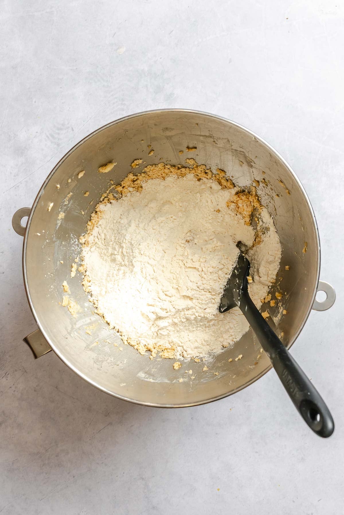 Process shot showing mixing ingredients together in a bowl.
