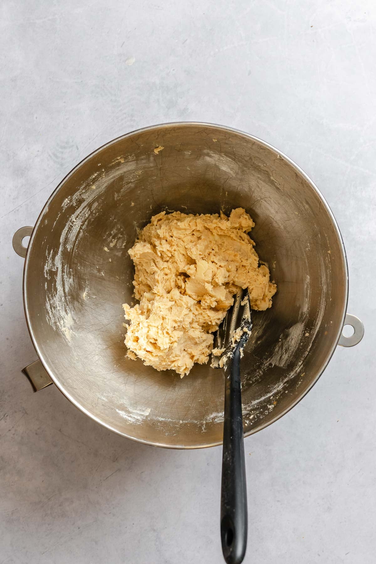Process shot showing mixing ingredients together in a bowl.