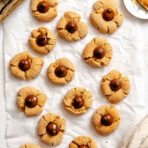 Completed Peanut Butter Blossoms on white surface.