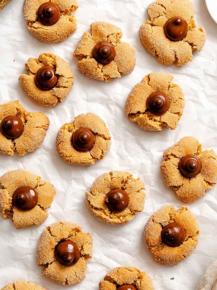Completed Peanut Butter Blossoms on white surface.
