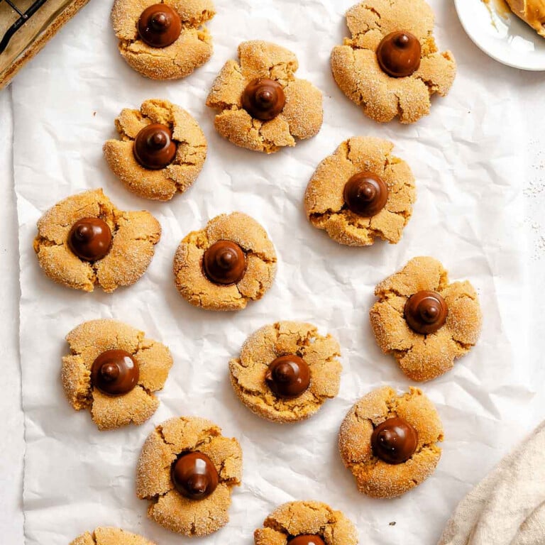 Completed Peanut Butter Blossoms on white surface.