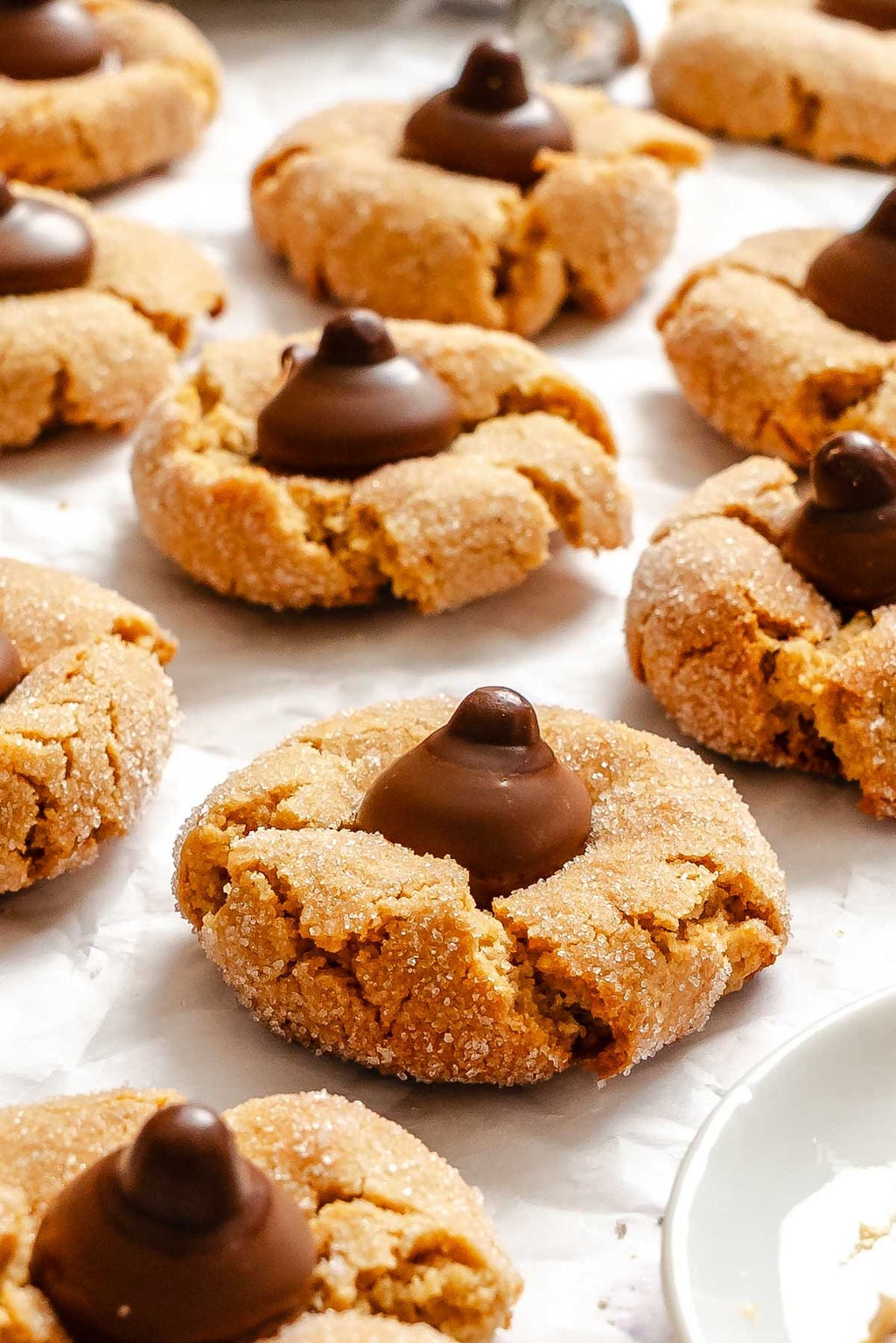 Completed Peanut Butter Blossoms on white surface.