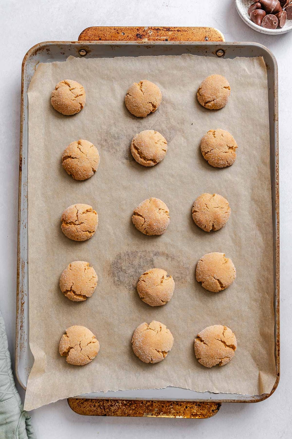 Process shot showing post baked cookies on baking sheet.