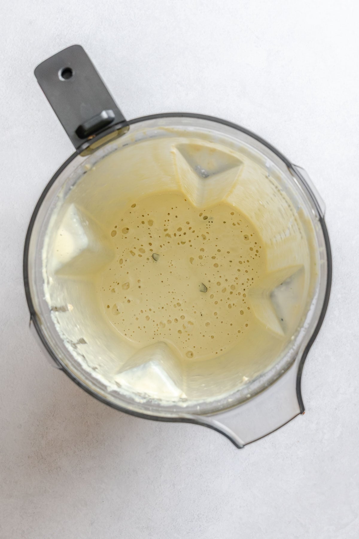 Process shot showing ingredients blended in blender.