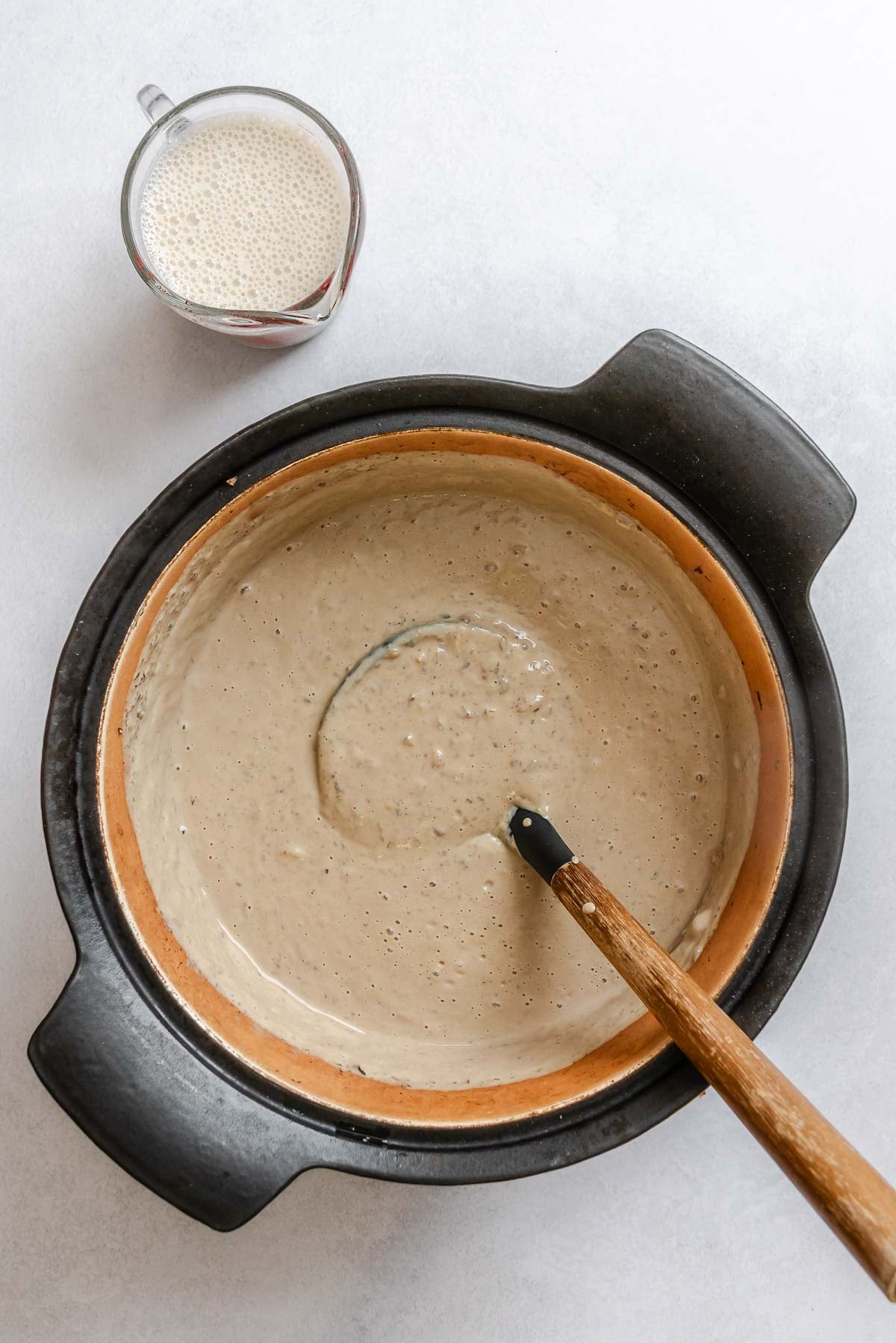 Process shot showing stirring ingredients in a pot.