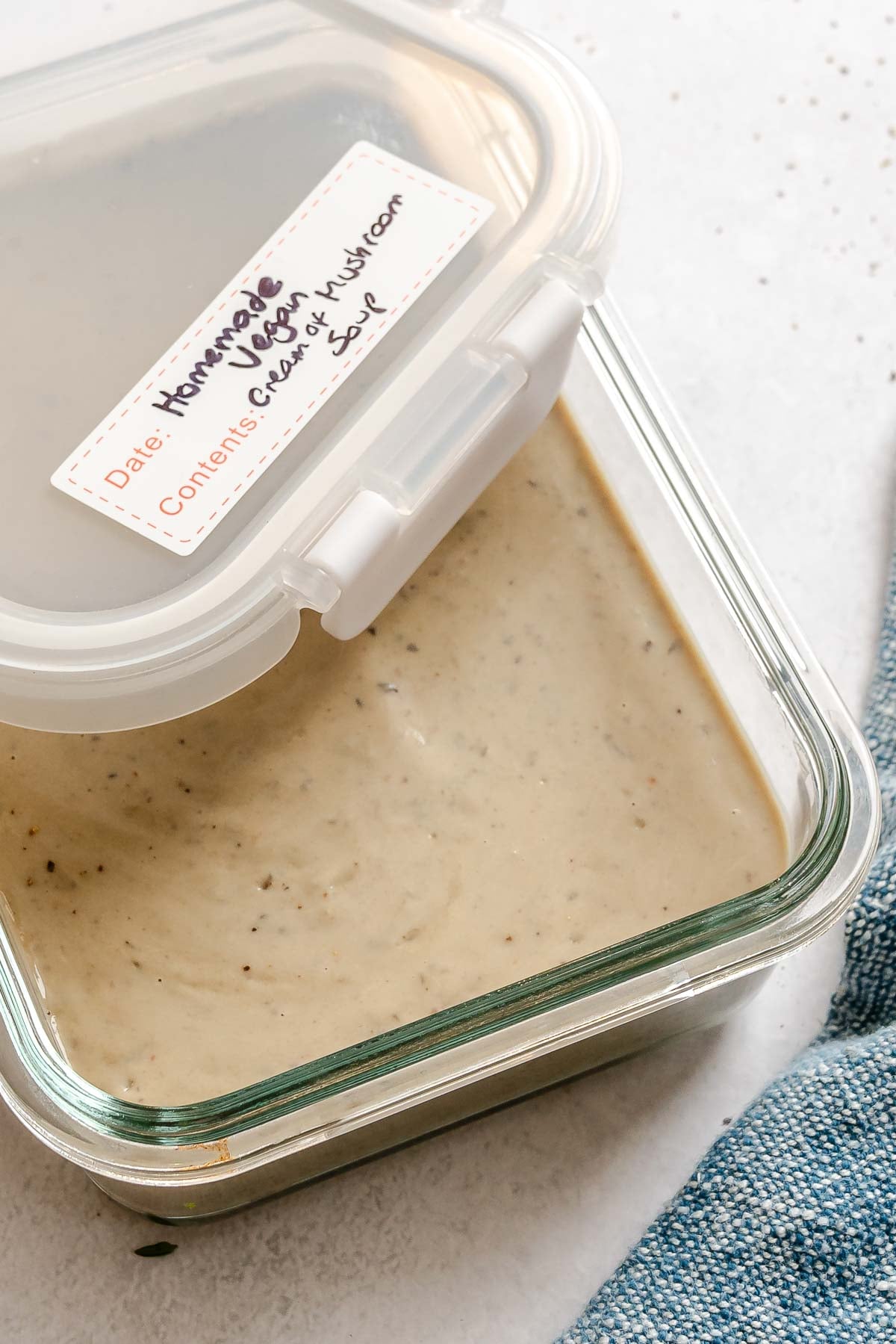 Completed Vegan Cream of Mushroom Soup in a storage container.