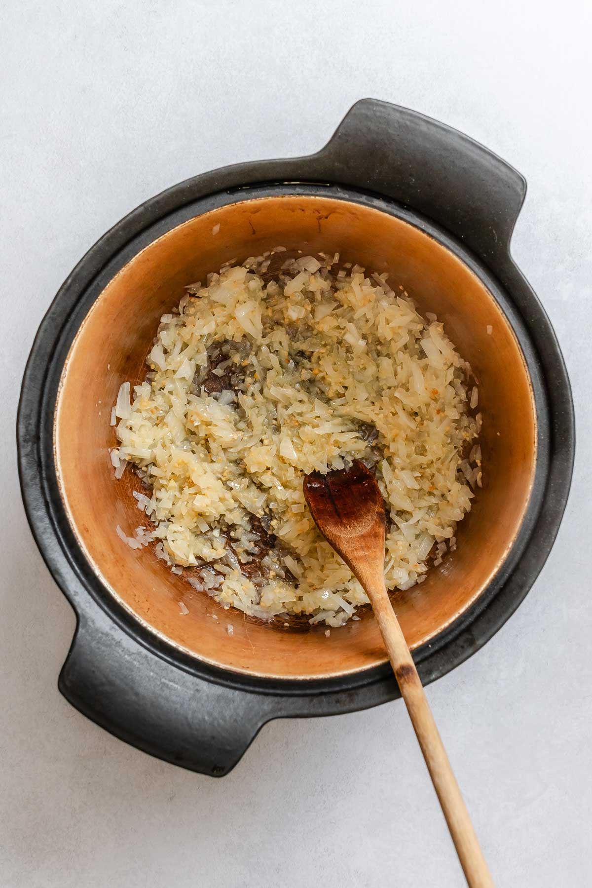 Process shot showing stirring ingredients in a pot.