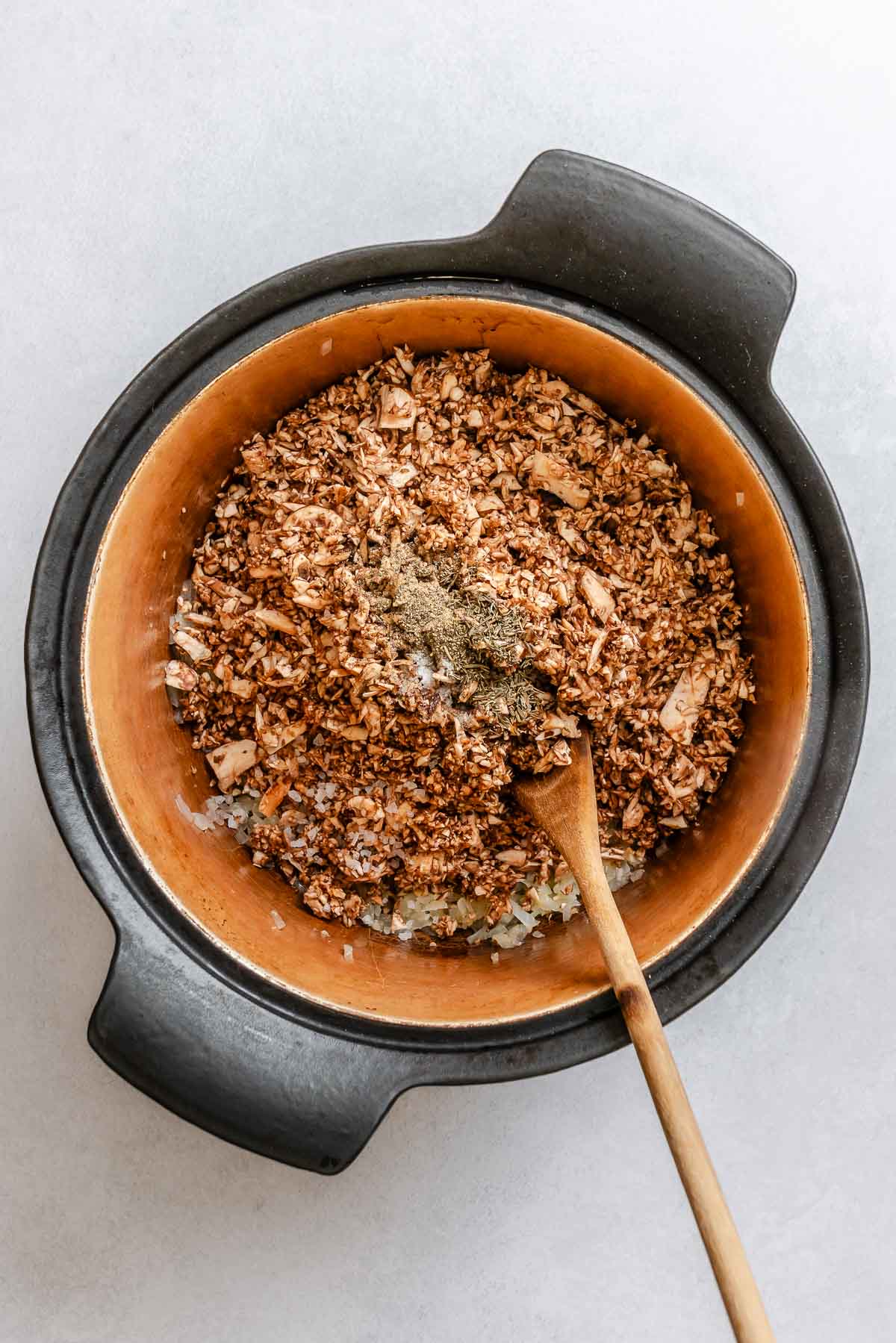 Process shot showing stirring ingredients in a pot.