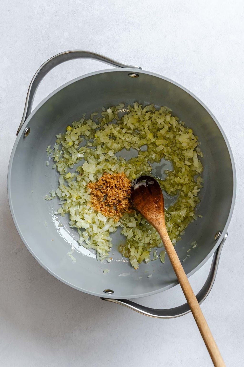 Process shot showing stirring ingredients in a pot.