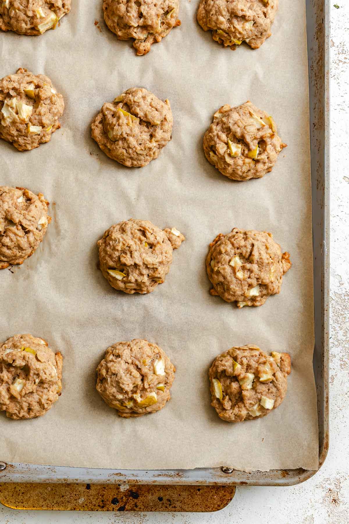 Process shot showing cookies on baking tray.