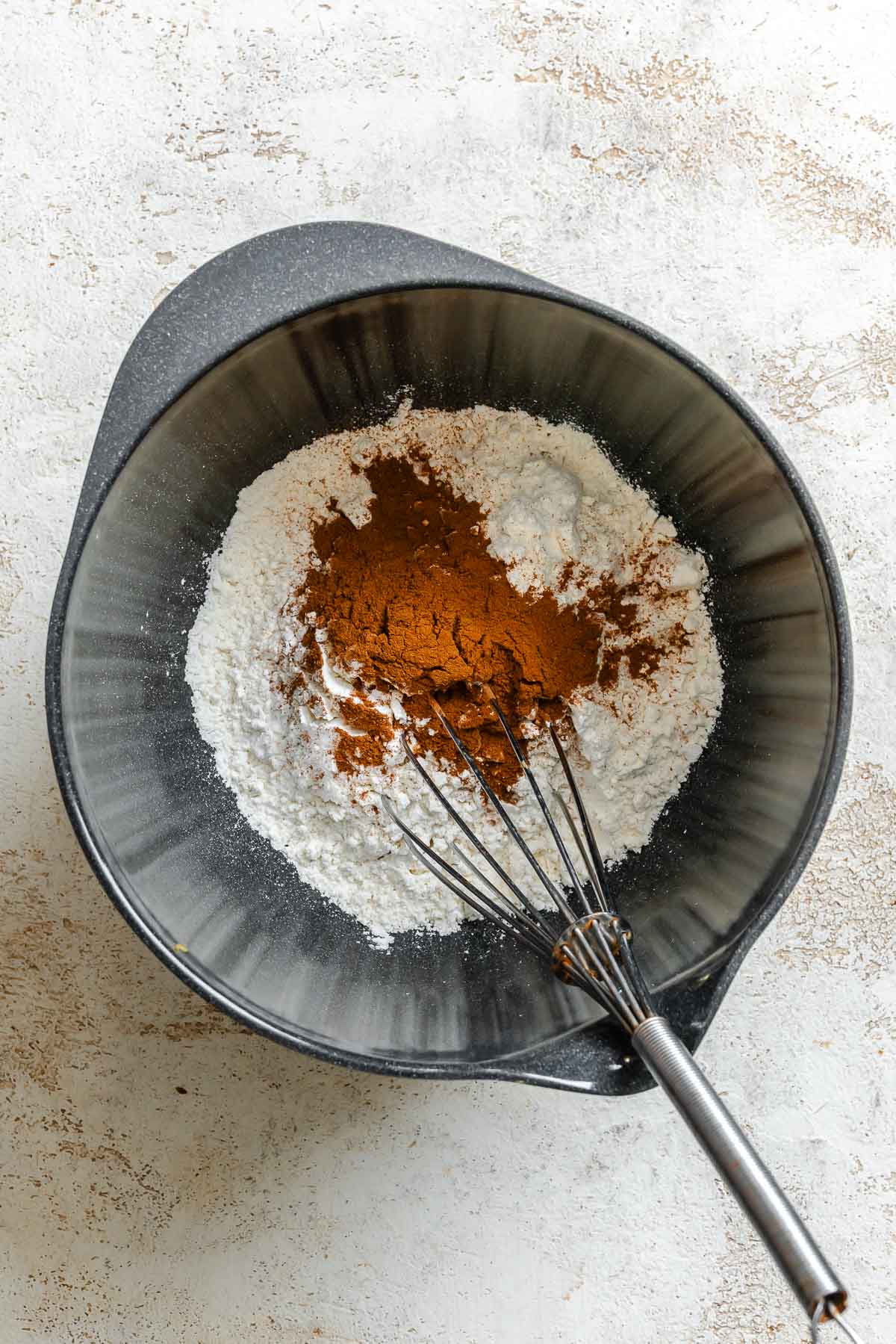 Process shot showing mixing ingredients in a bowl.