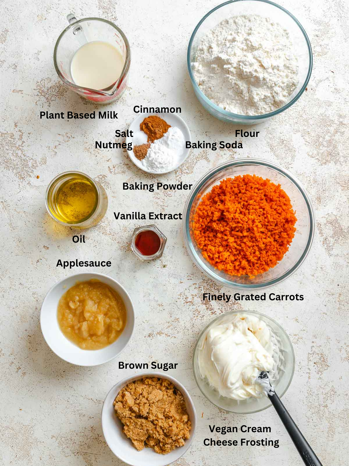 Ingredients for Vegan Carrot Cake measured out on a white surface.