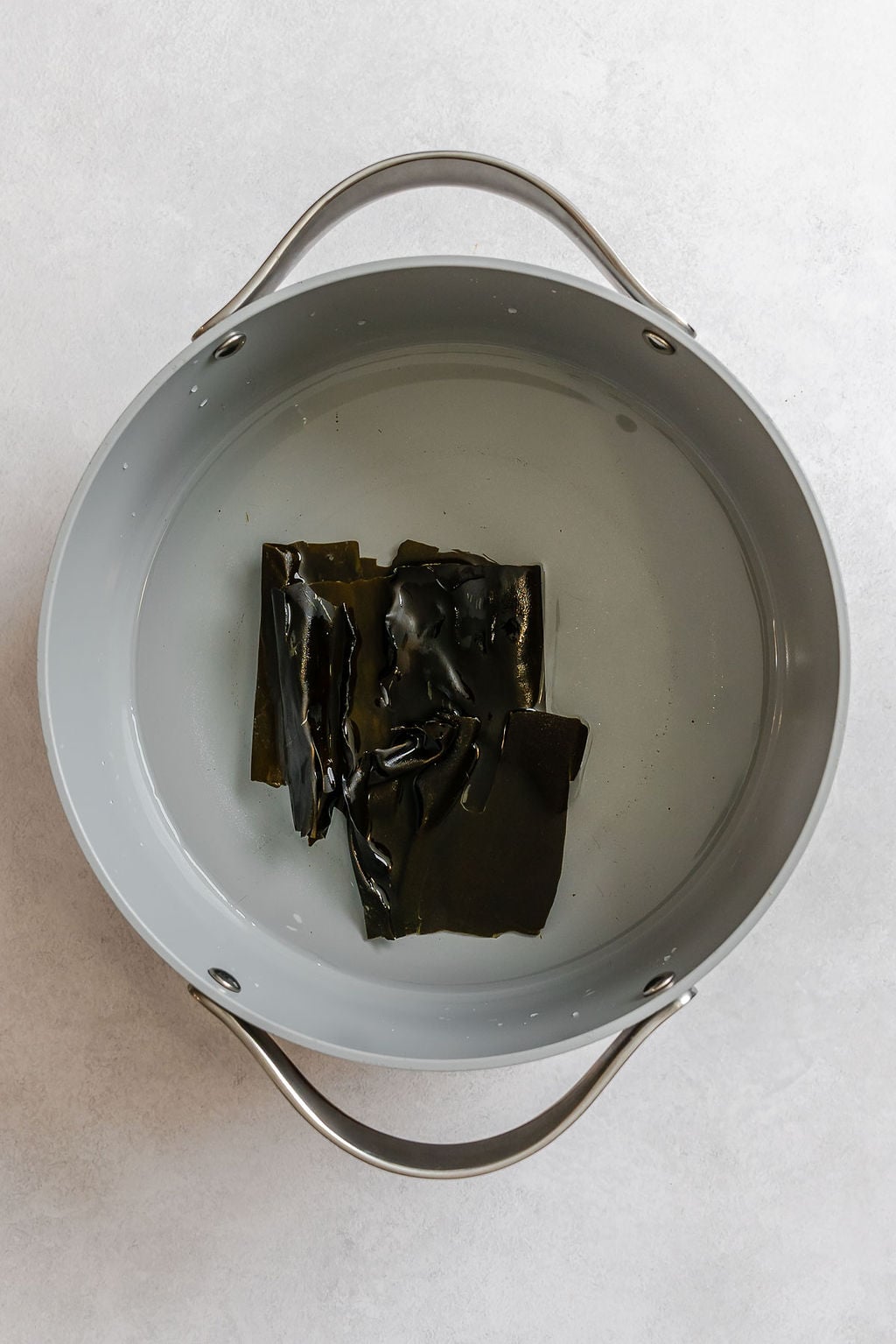 Process shot showing kombu added to pot.