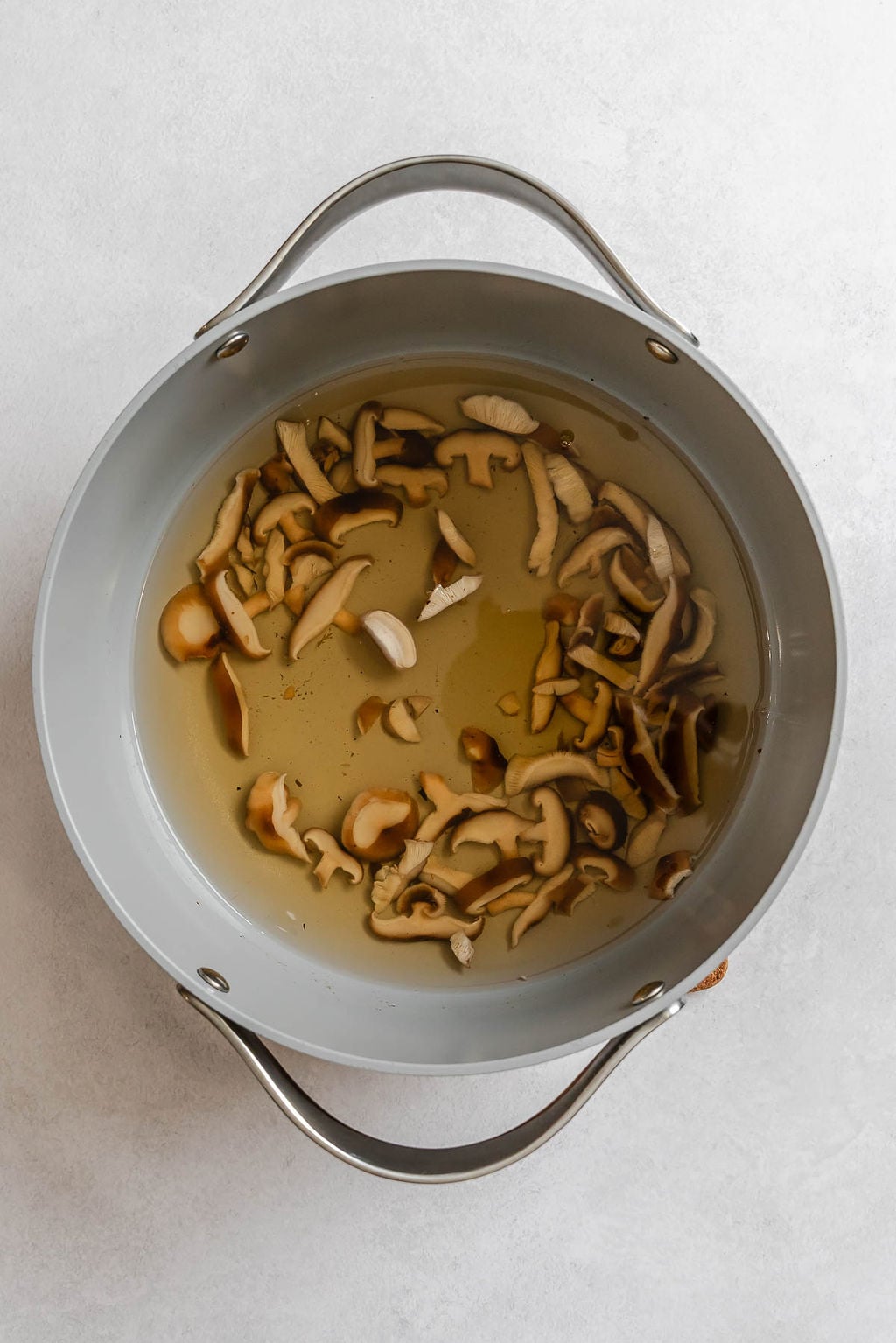 Process shot showing ingredients cooking inside pot.