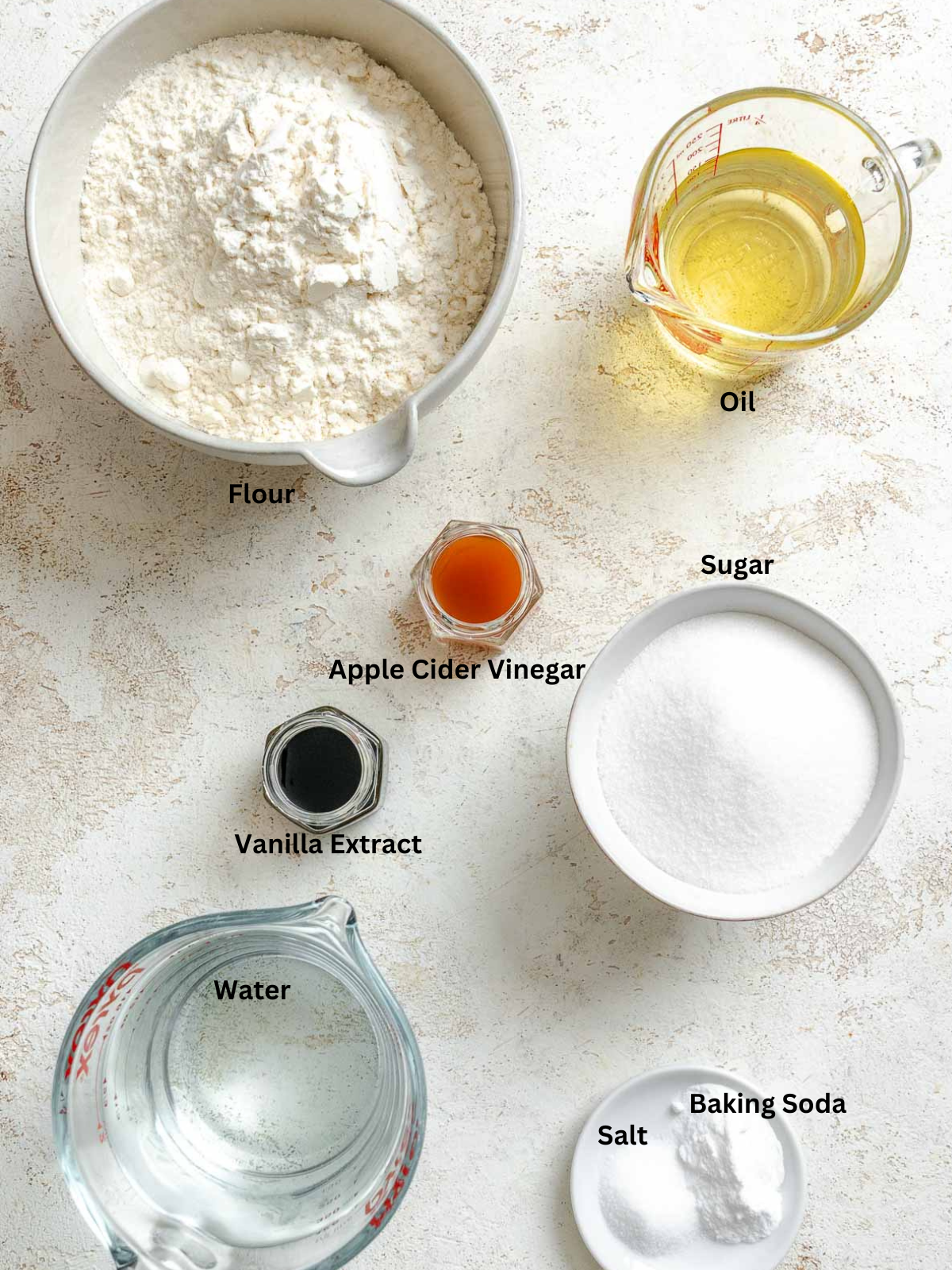 Ingredients for Vegan Sheet Cake (Vanilla) measured out on a white surface.