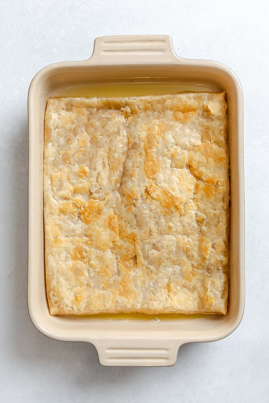 Process shot showing ingredients added to baking dish.