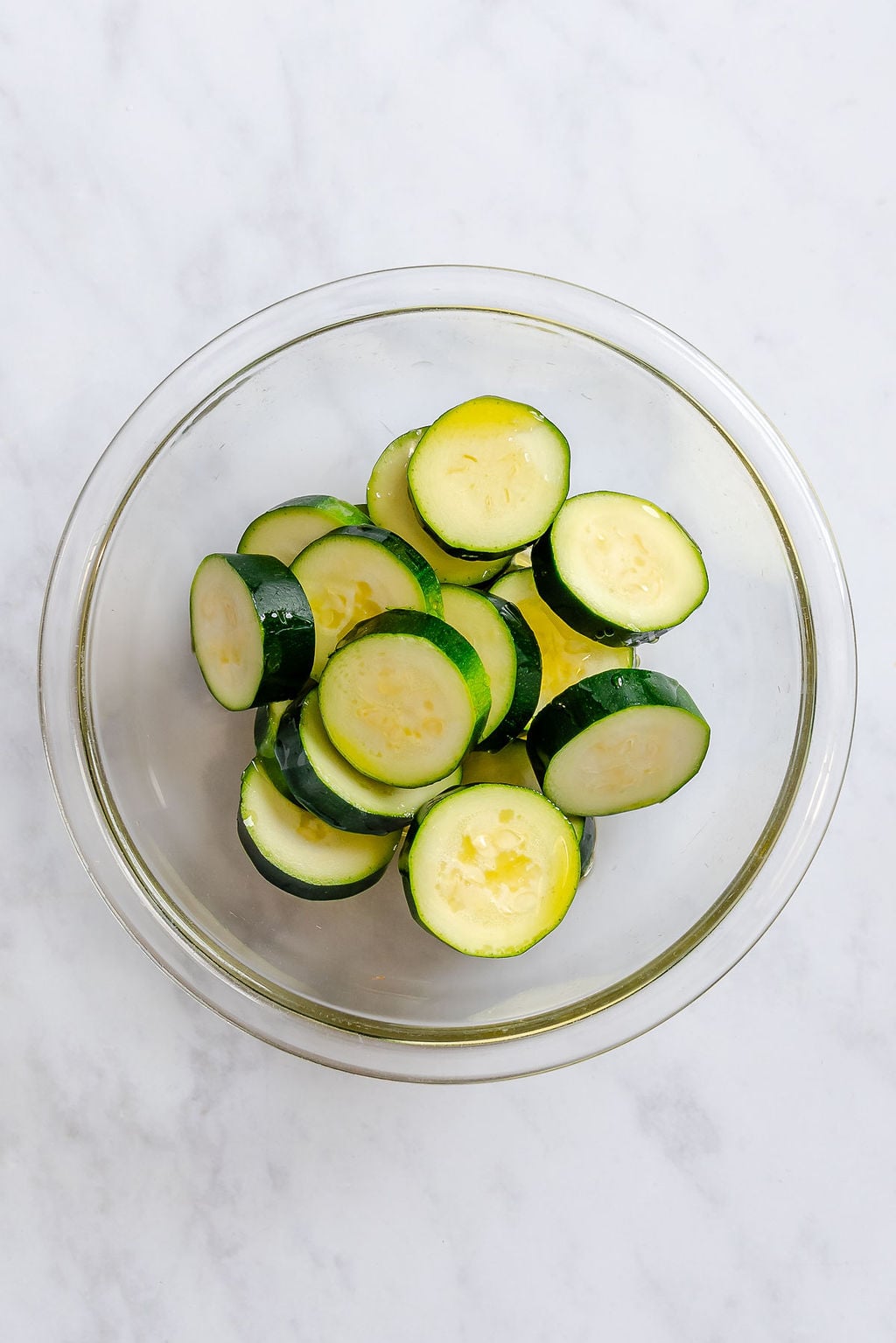 Process shot showing cut zucchini in a bowl.