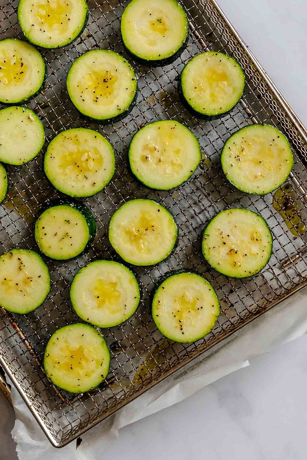 Process shot showing zucchini on air fryer rack.