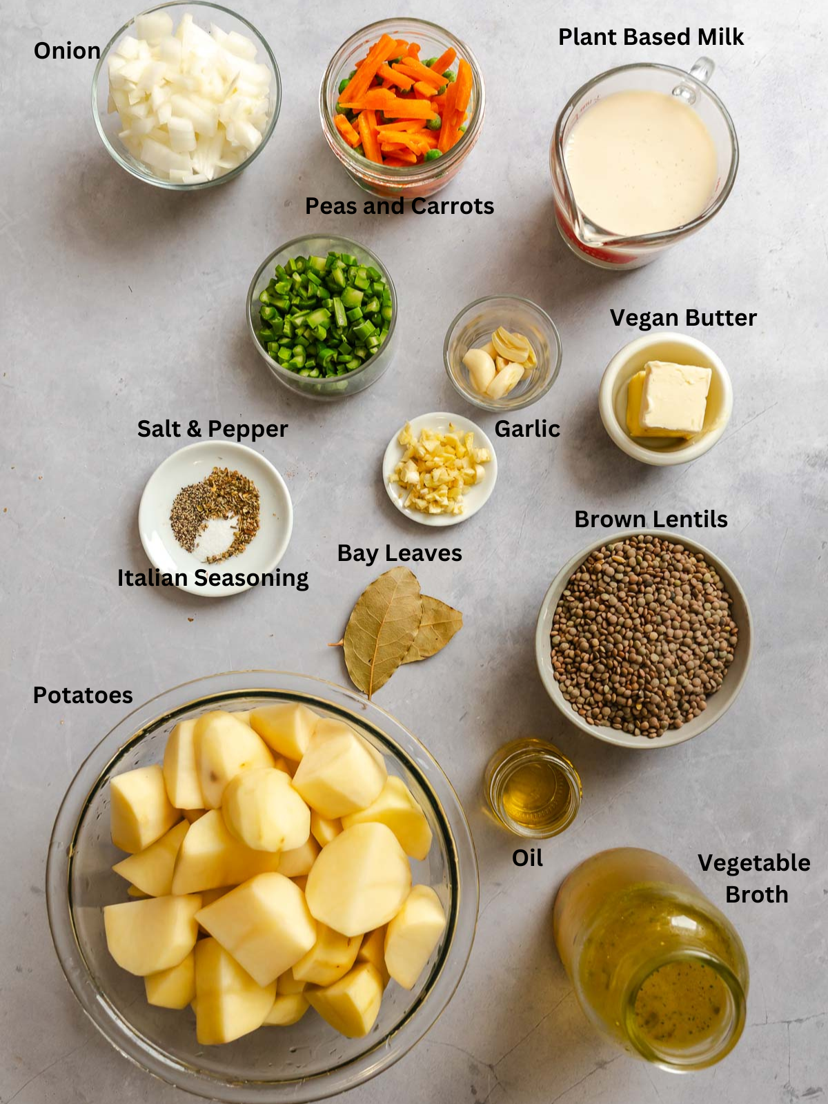 Ingredients for Vegan Lentil Shepherd's Pie measured out on a white surface.