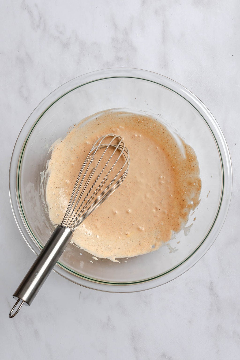 Process shot showing mixing ingredients in a bowl.