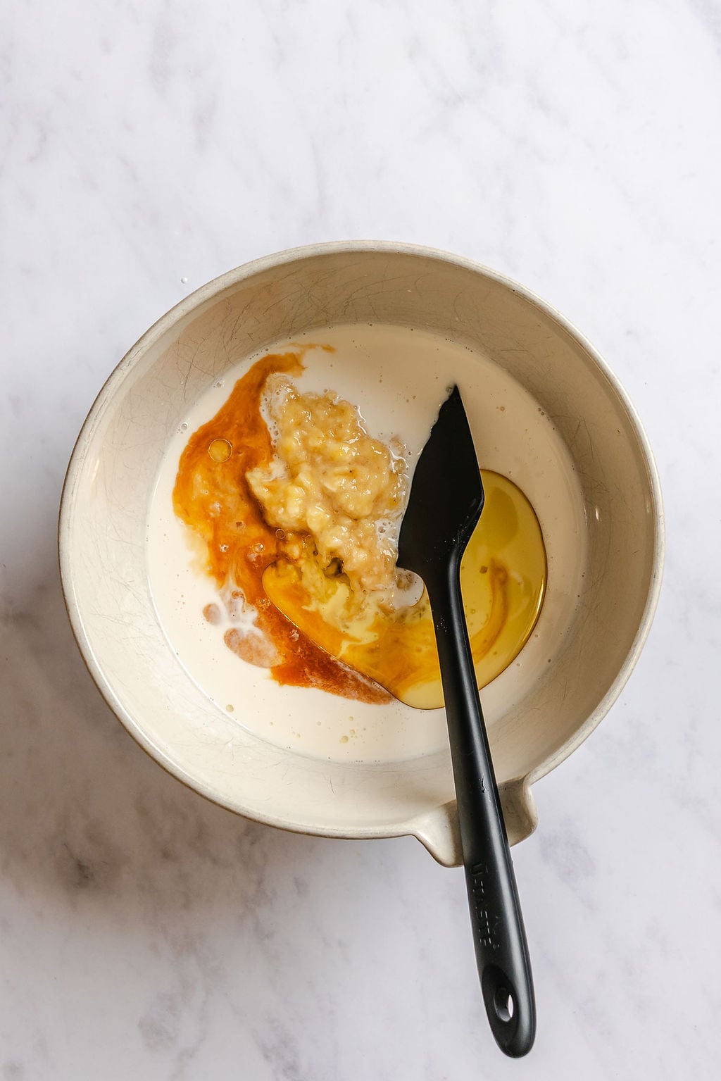 Process shot showing mixing ingredients in a bowl.
