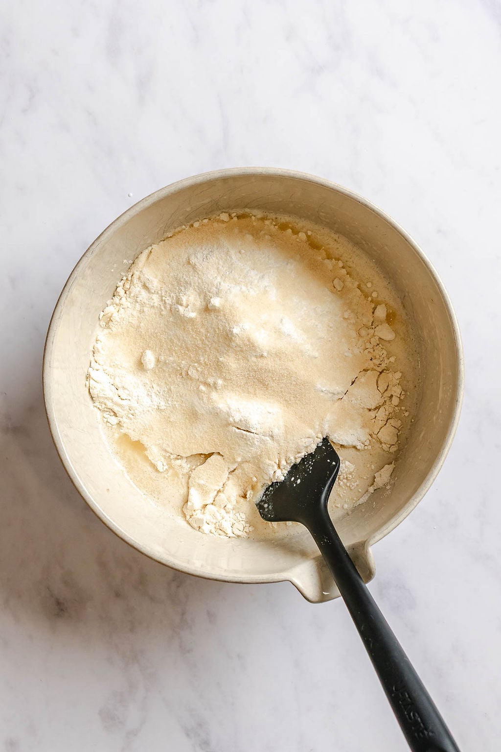 Process shot showing mixing ingredients in a bowl.