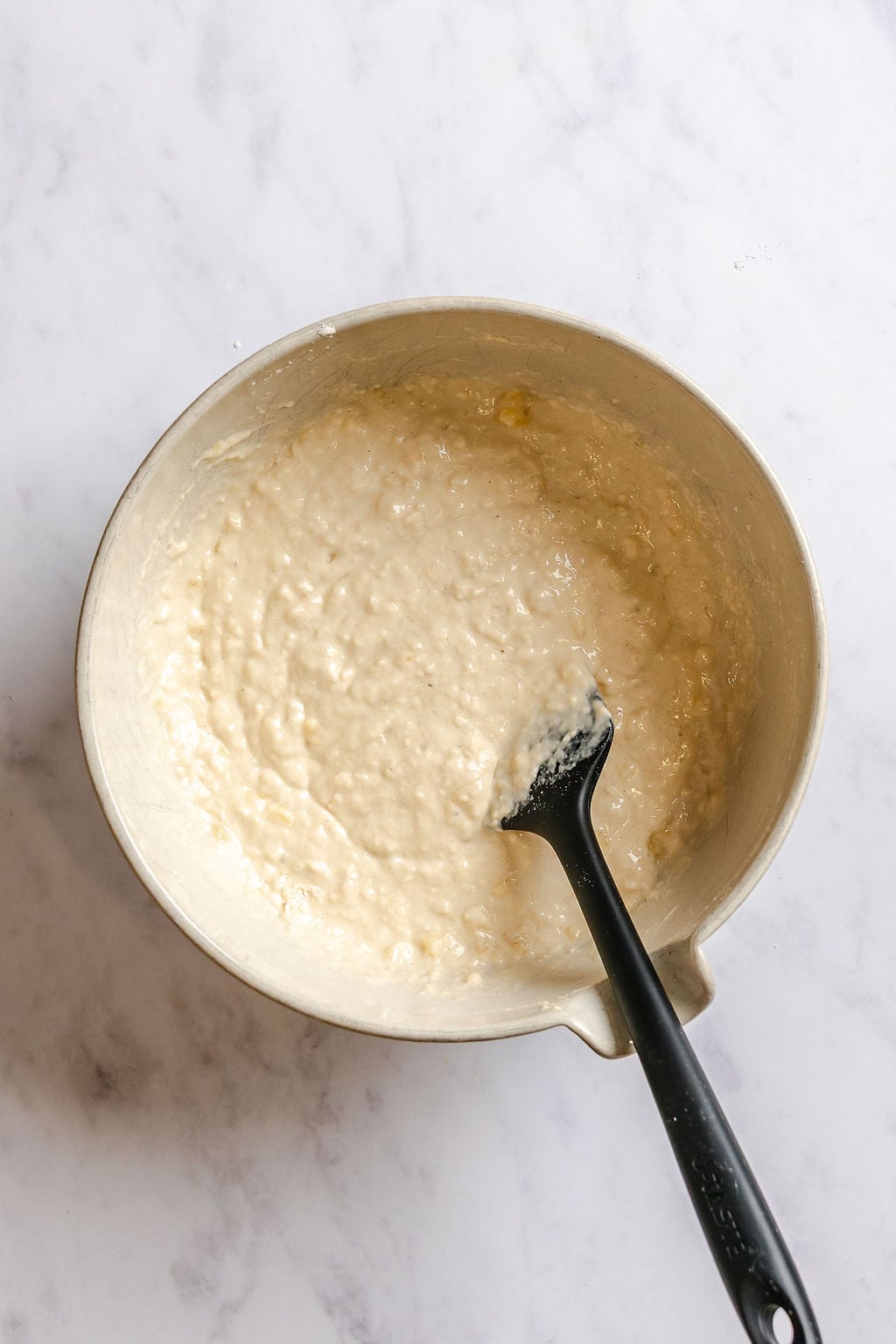 Process shot showing mixing ingredients in a bowl.