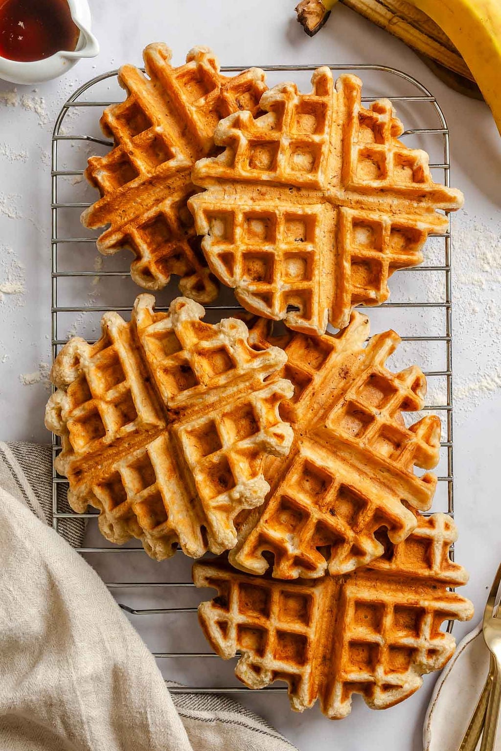 Process shot showing waffles cooking on wire rack.