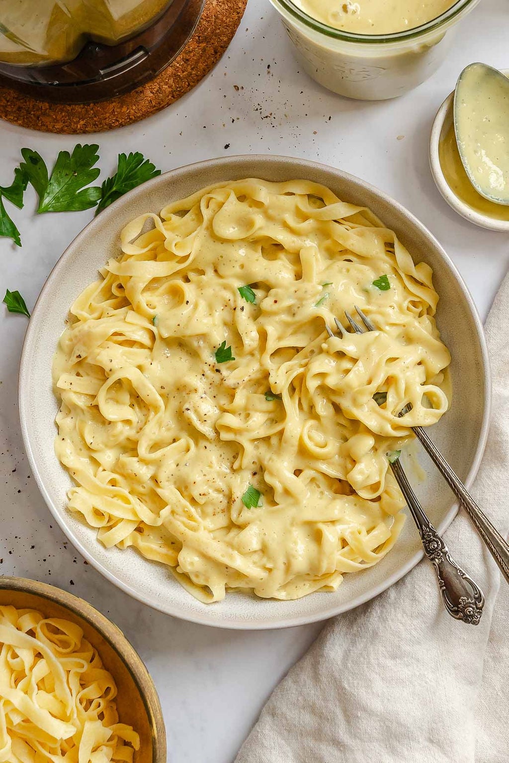 Completed Healthy Cauliflower Alfredo Sauce on pasta on a plate.