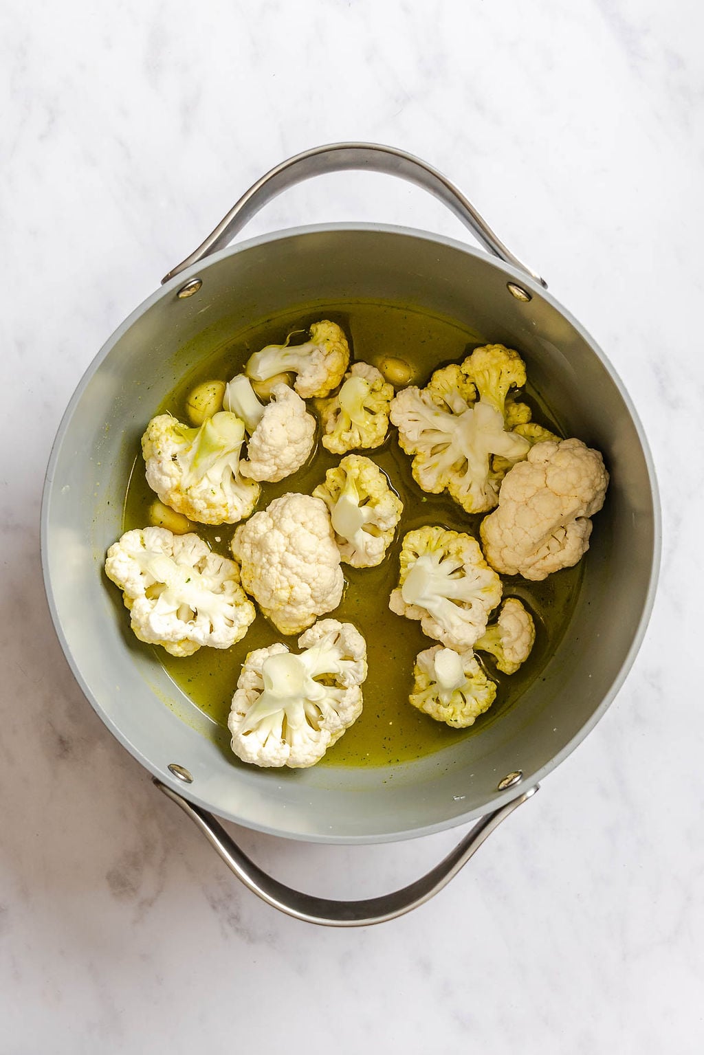 Process shot showing cauliflower in a pot.