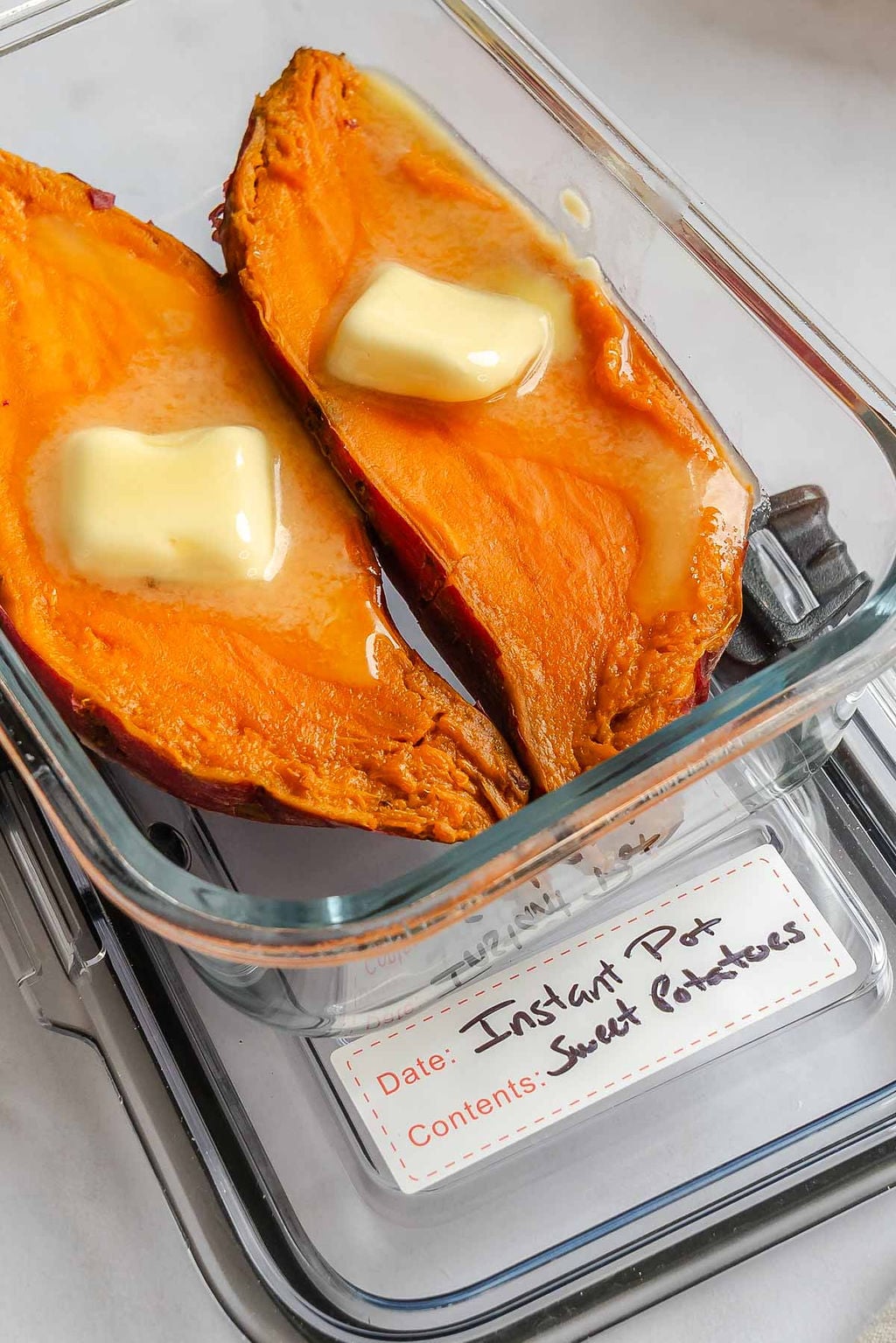 Completed Instant Pot Sweet Potatoes in a storage container.