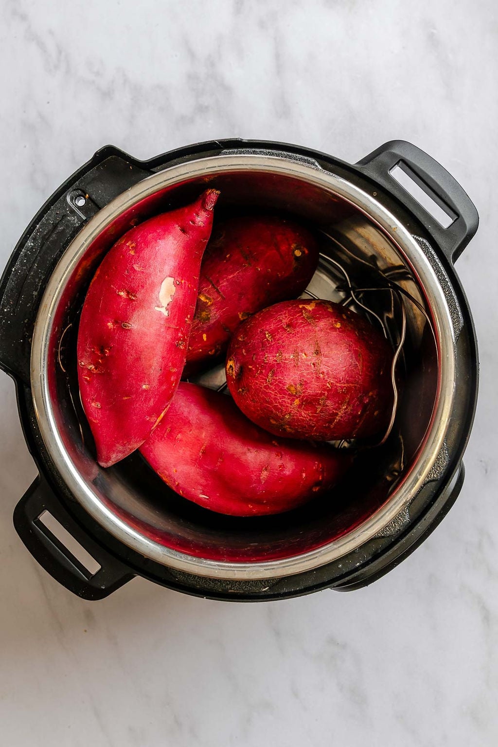 Process shot showing sweet potatoes in an instant pot.