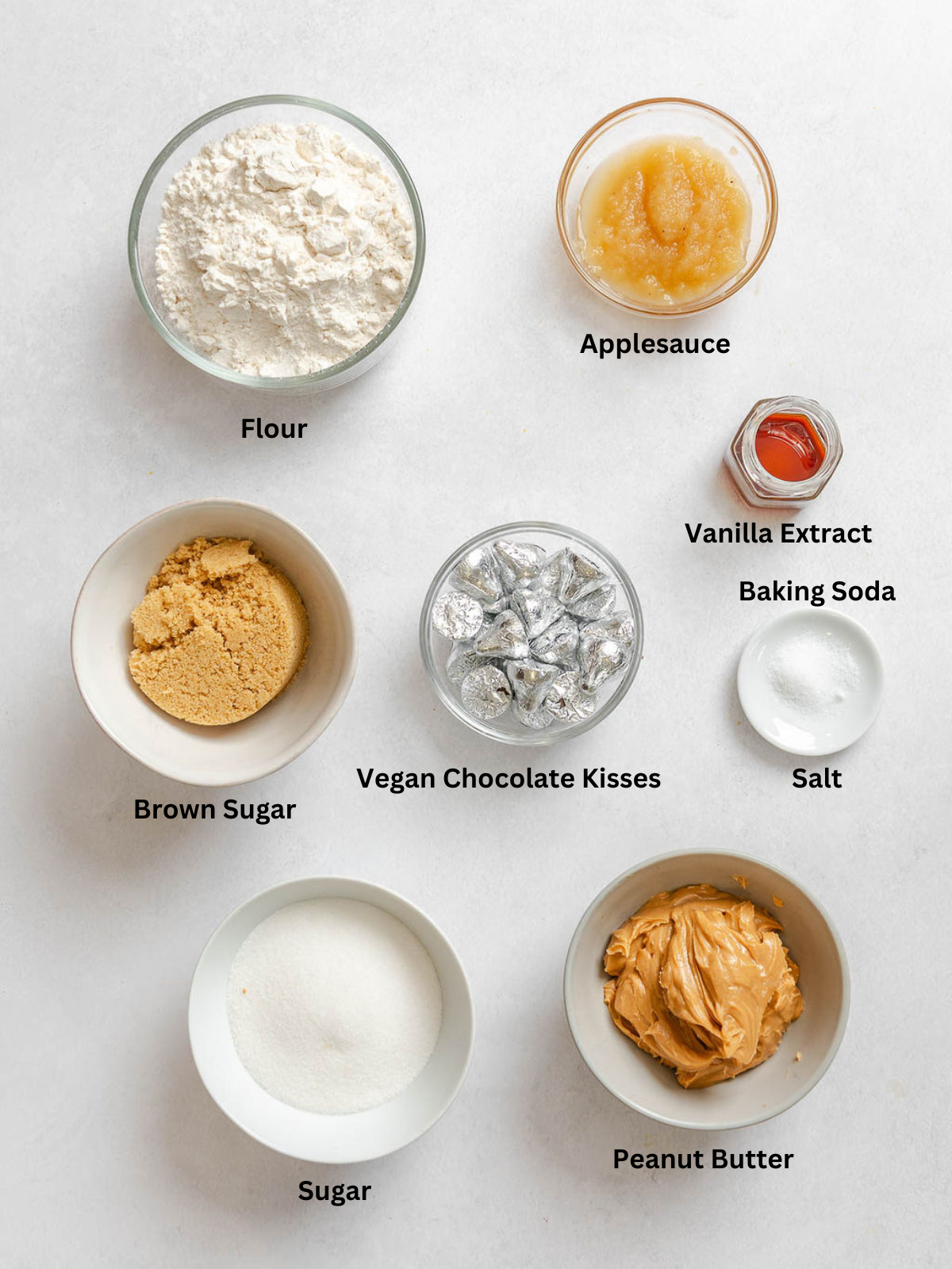 Ingredients for Peanut Butter Blossoms measured out on a white surface.