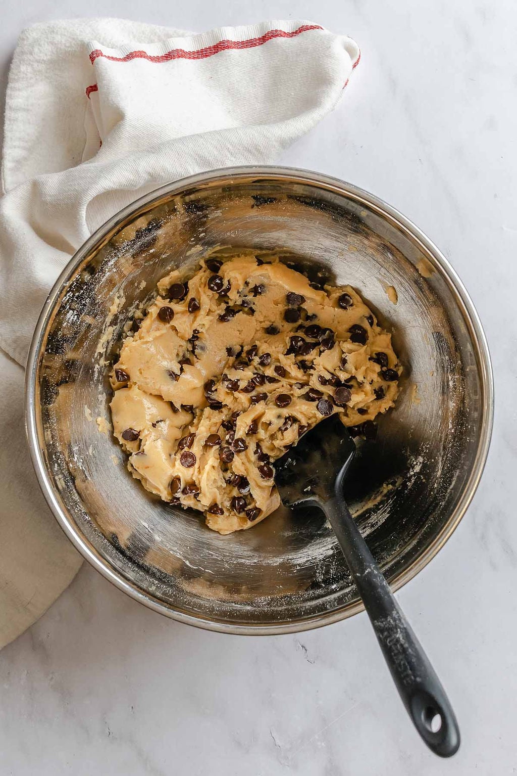 Process shot showing mixing cookie dough in bowl.