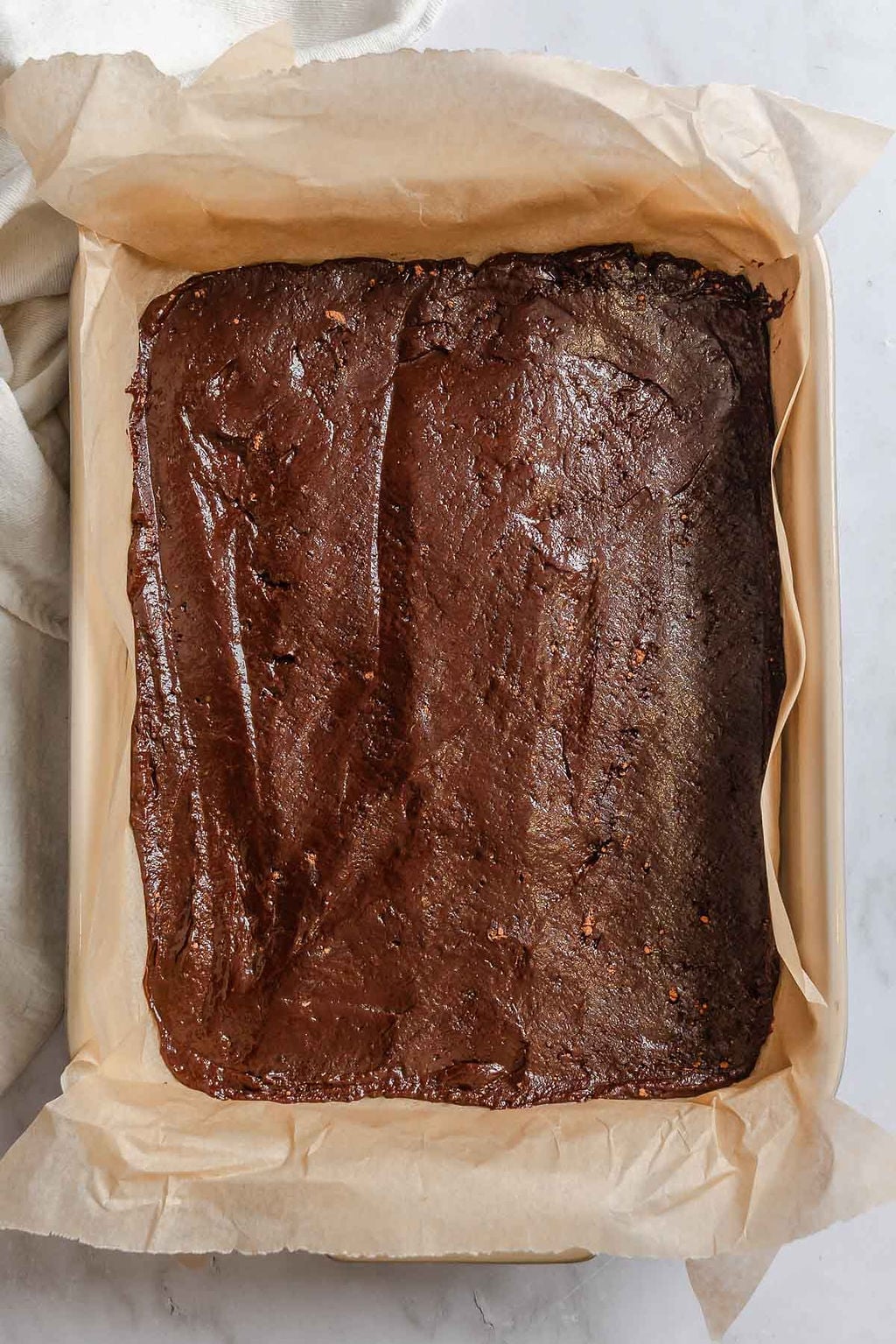 Process shot showing brownie mixture in a baking dish.