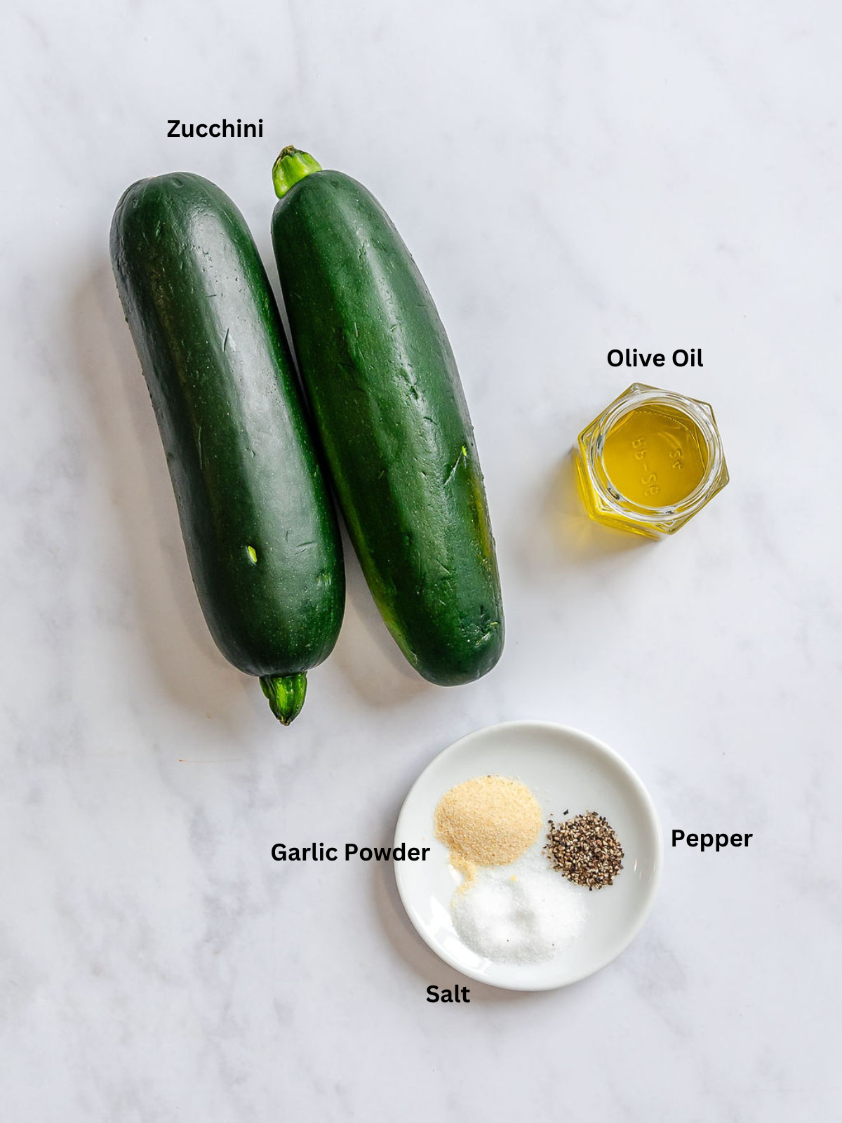 Ingredients for Quick Air Fryer Zucchini measured out on a white surface.