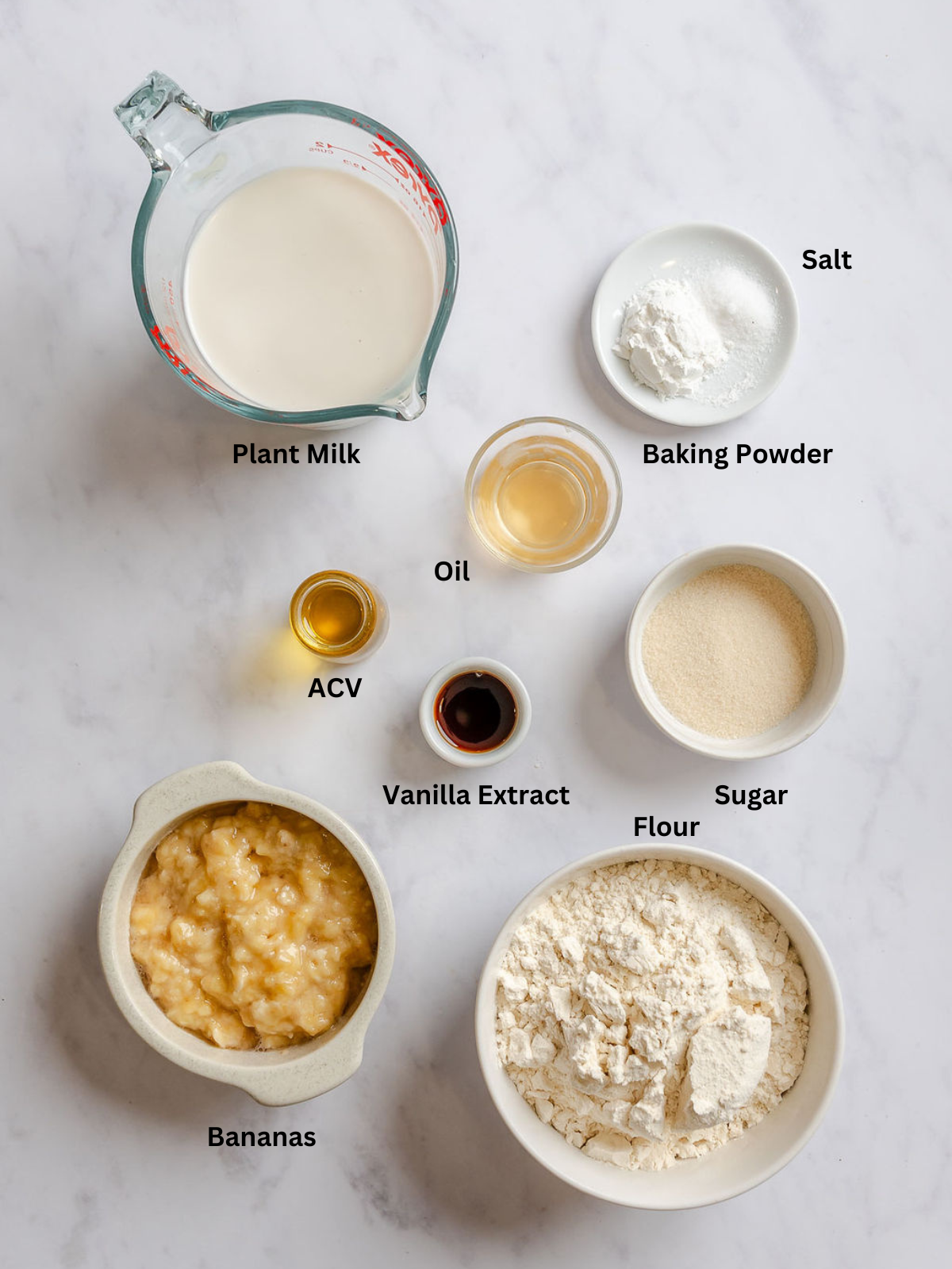 Ingredients for Easy Vegan Banana Waffles measured out on a white surface.