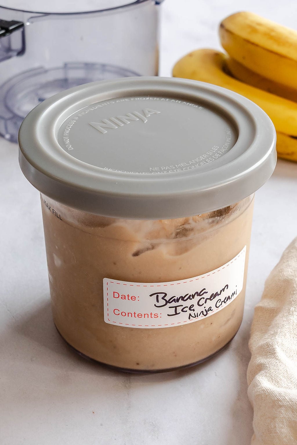 Completed Ninja Creami Banana Ice Cream in a storage container.