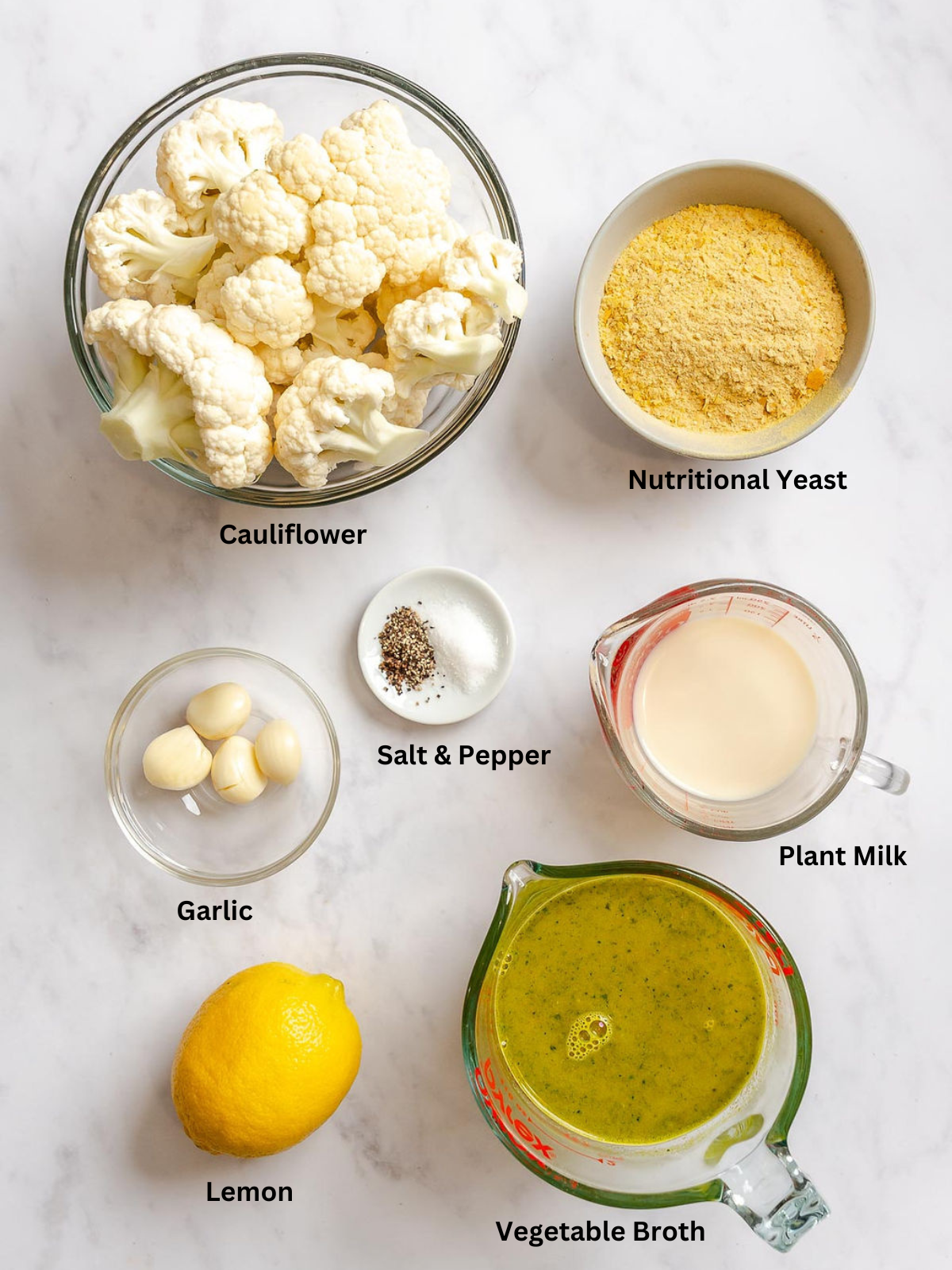 Ingredients for Healthy Cauliflower Alfredo Sauce measured out on a white surface.