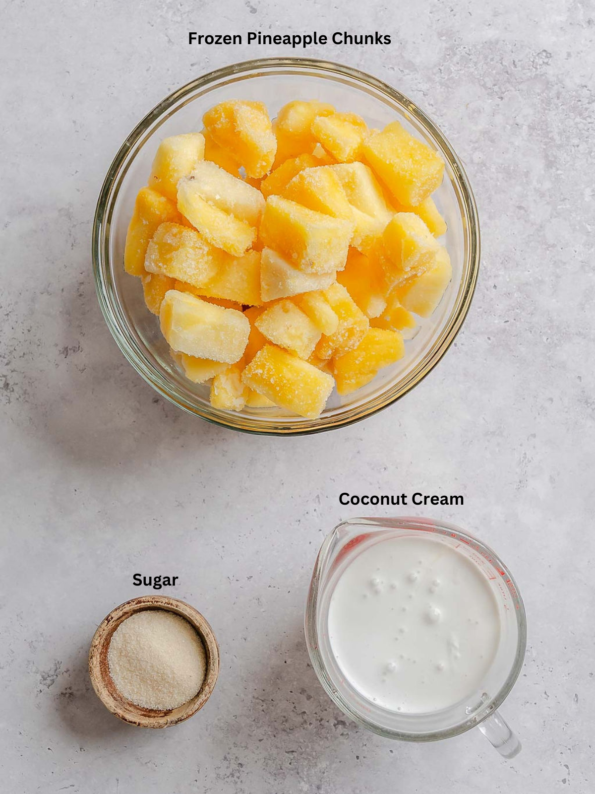 Ingredients for Ninja Creami Dole Whip measured out on a white surface.