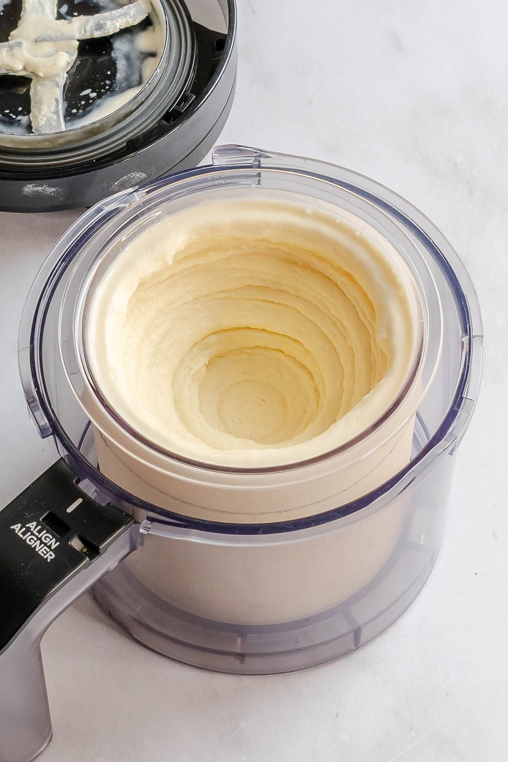 Process shot showing Ninja Creami Dole Whip in creami container.