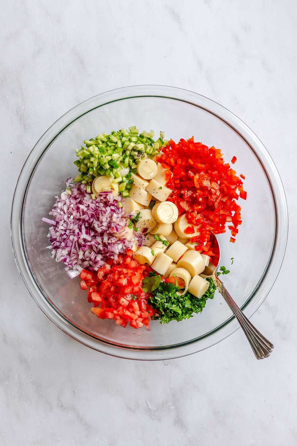 Process shot showing ingredients added to a bowl.