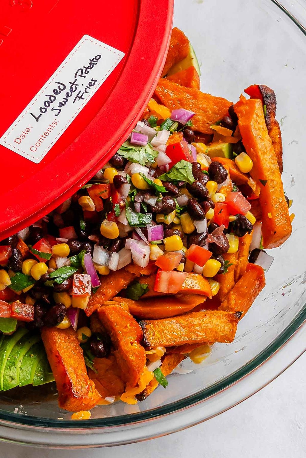 Completed Loaded Sweet Potato Fries in a storage container.